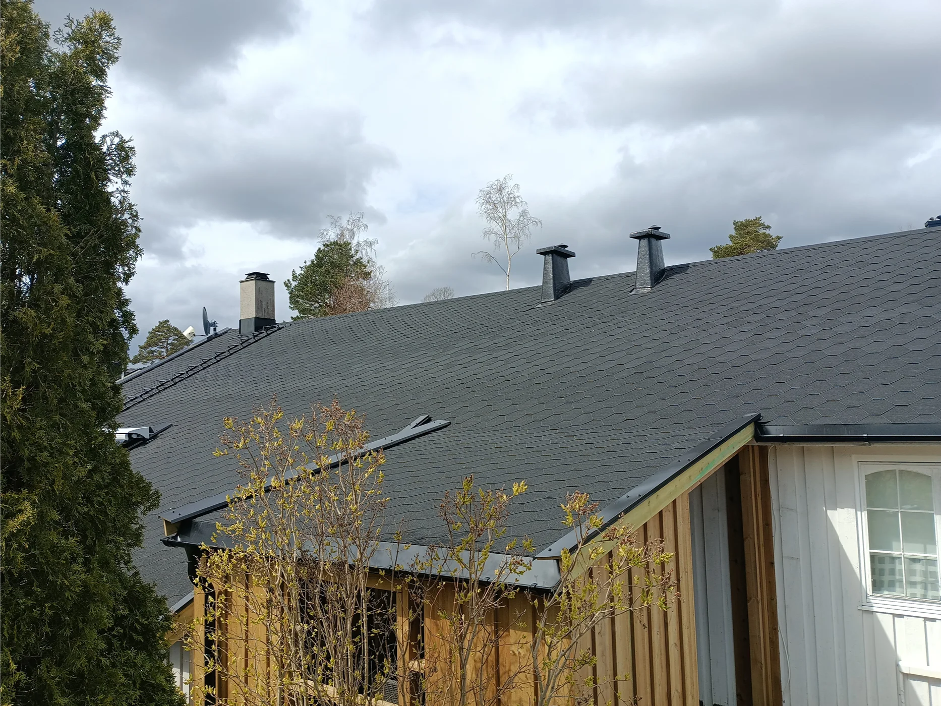 Modern home with dark slate roof installation