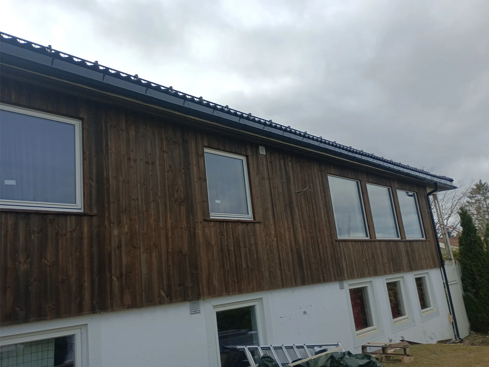 Modern home with dark wood and white plaster