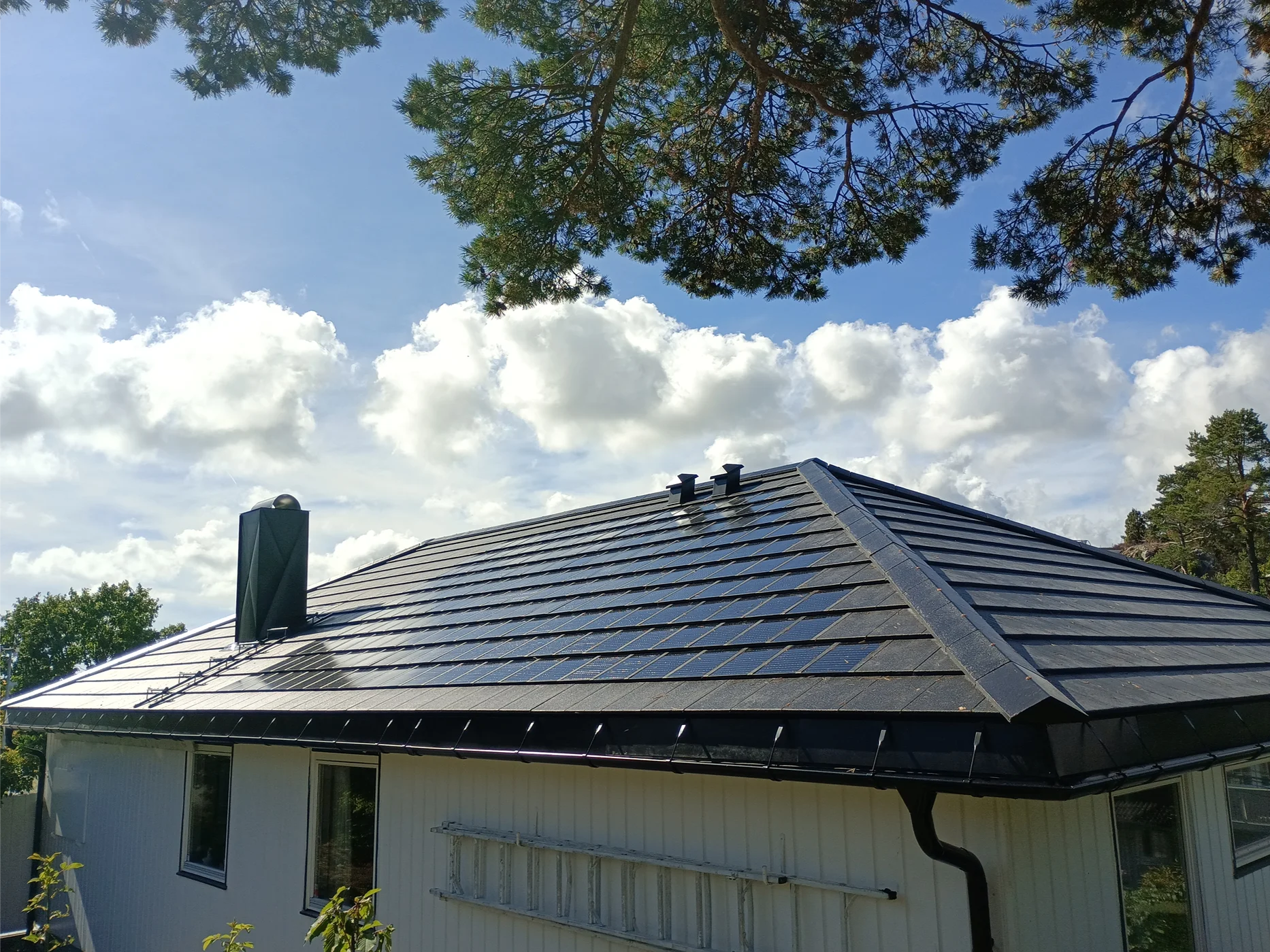 Modern residential house with dark metal roof installation