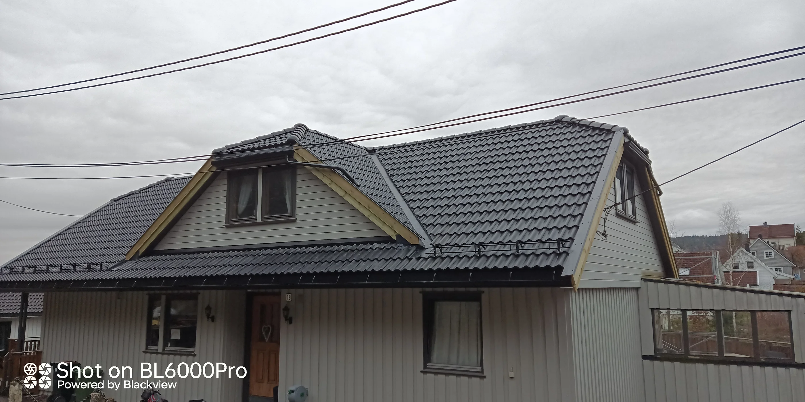 Modern residential house with dark tiled roof