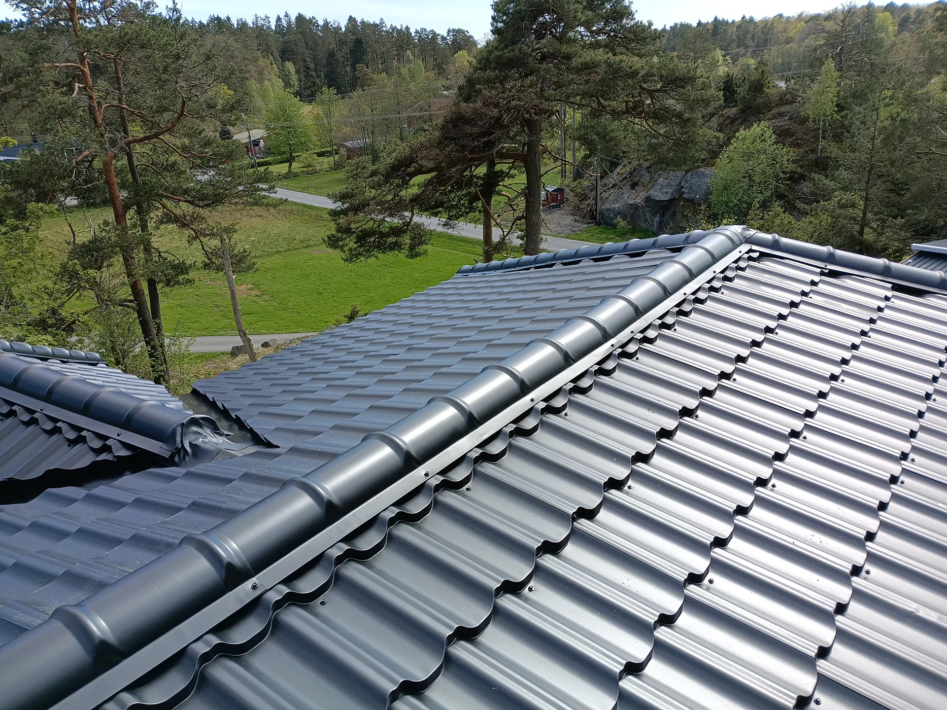 Modern metal roof installation with integrated gutter system