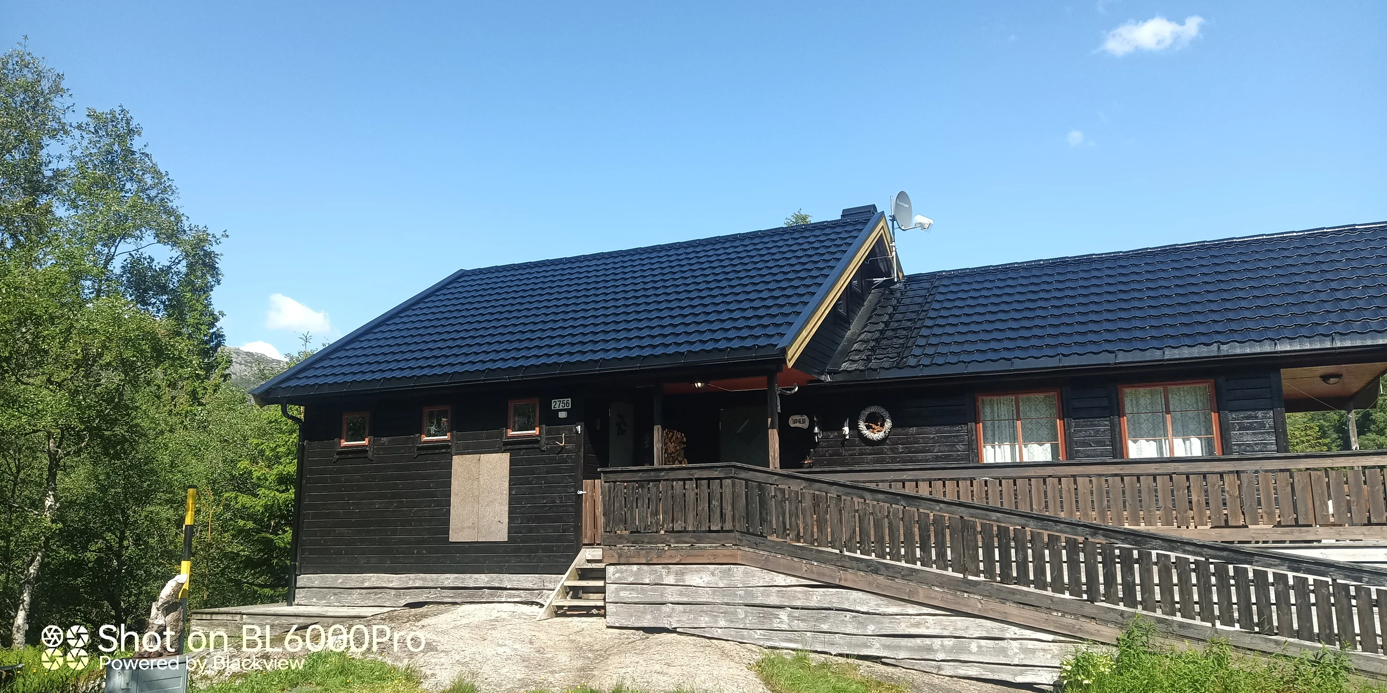 Modern dark wooden house with timber deck exterior