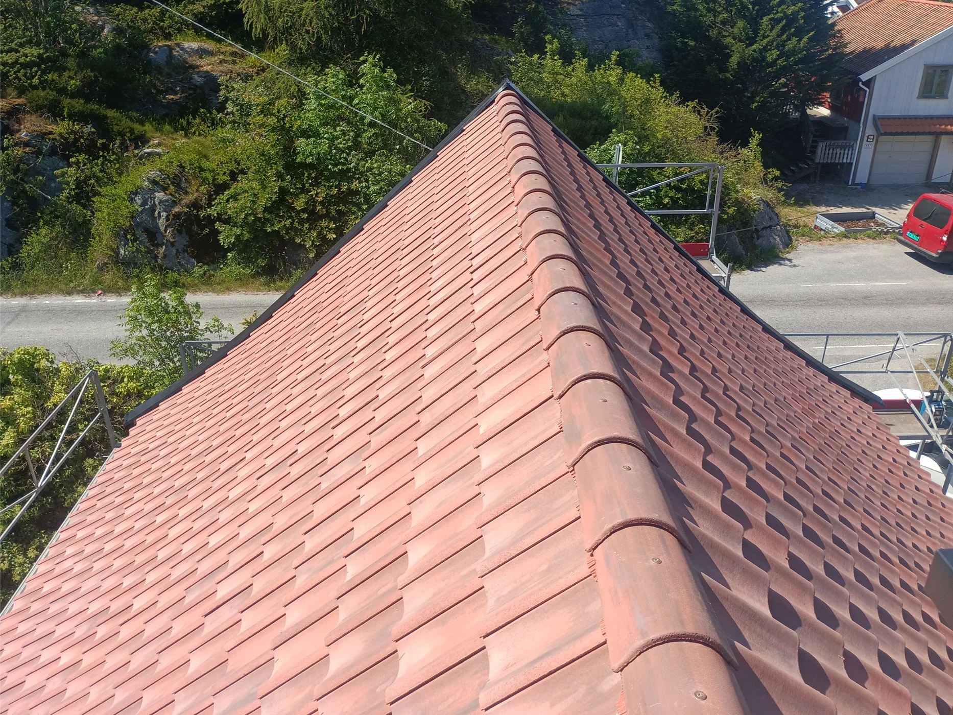 Red tile roof installed on residential building