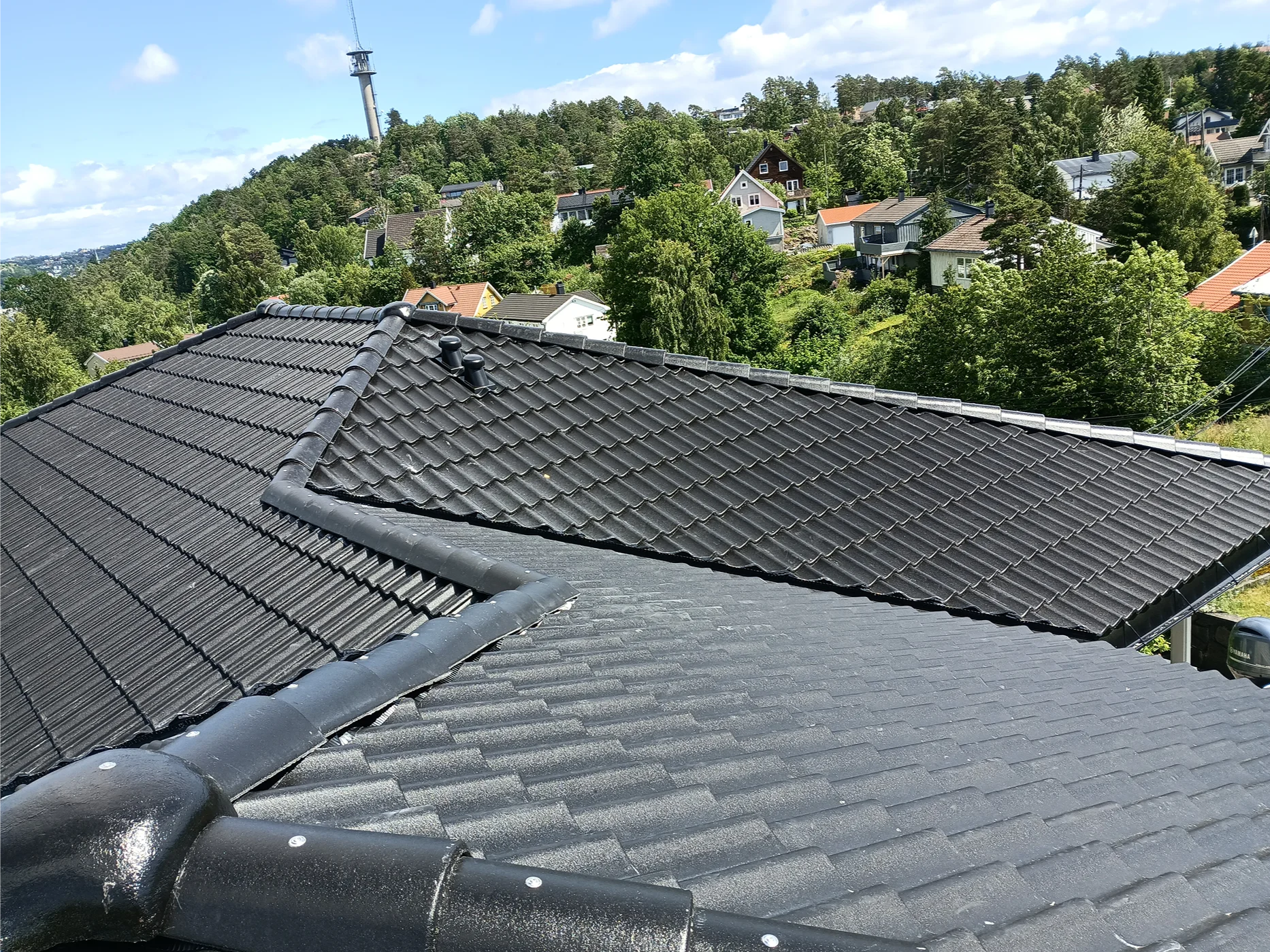 New black roof installation residential neighborhood view