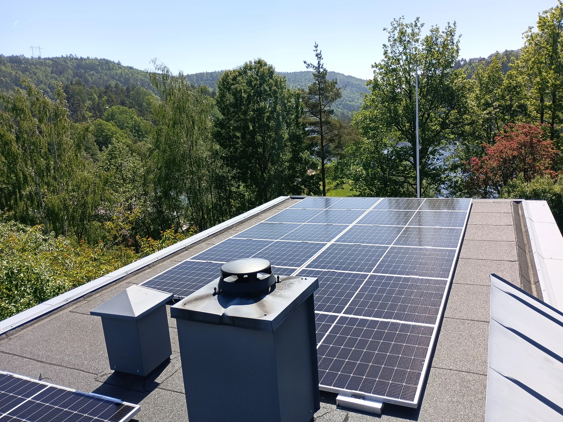 Solar panels installed on rooftop with mountain views
