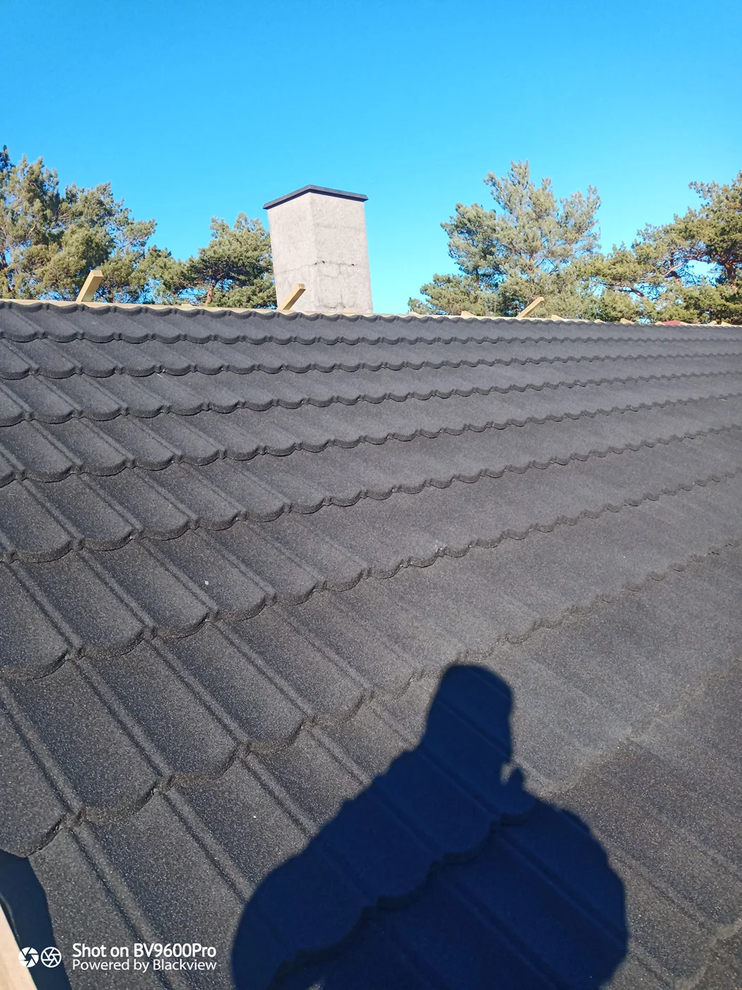 Corrugated metal roof with chimney installation