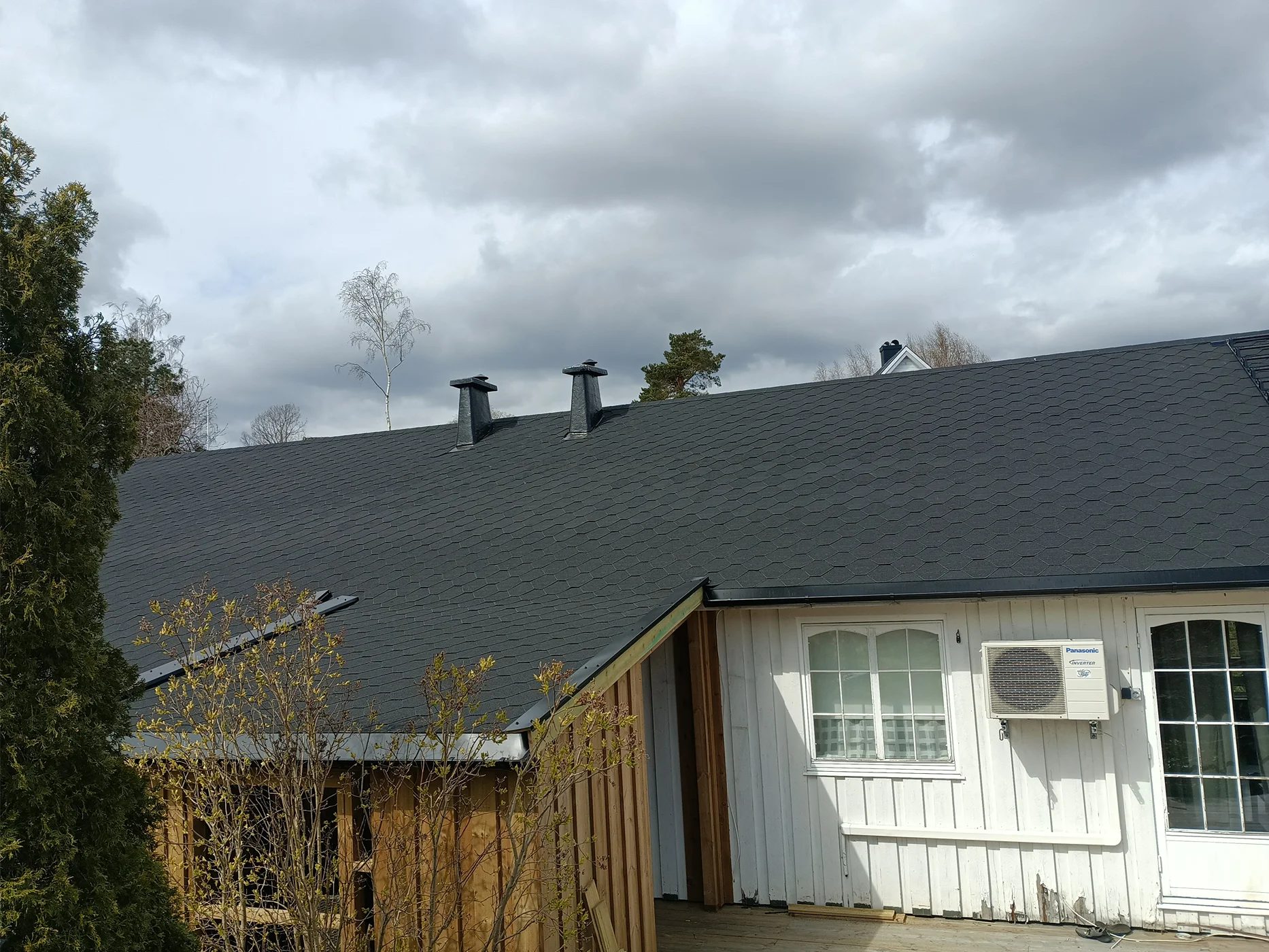 Modern house exterior with dark shingled roof