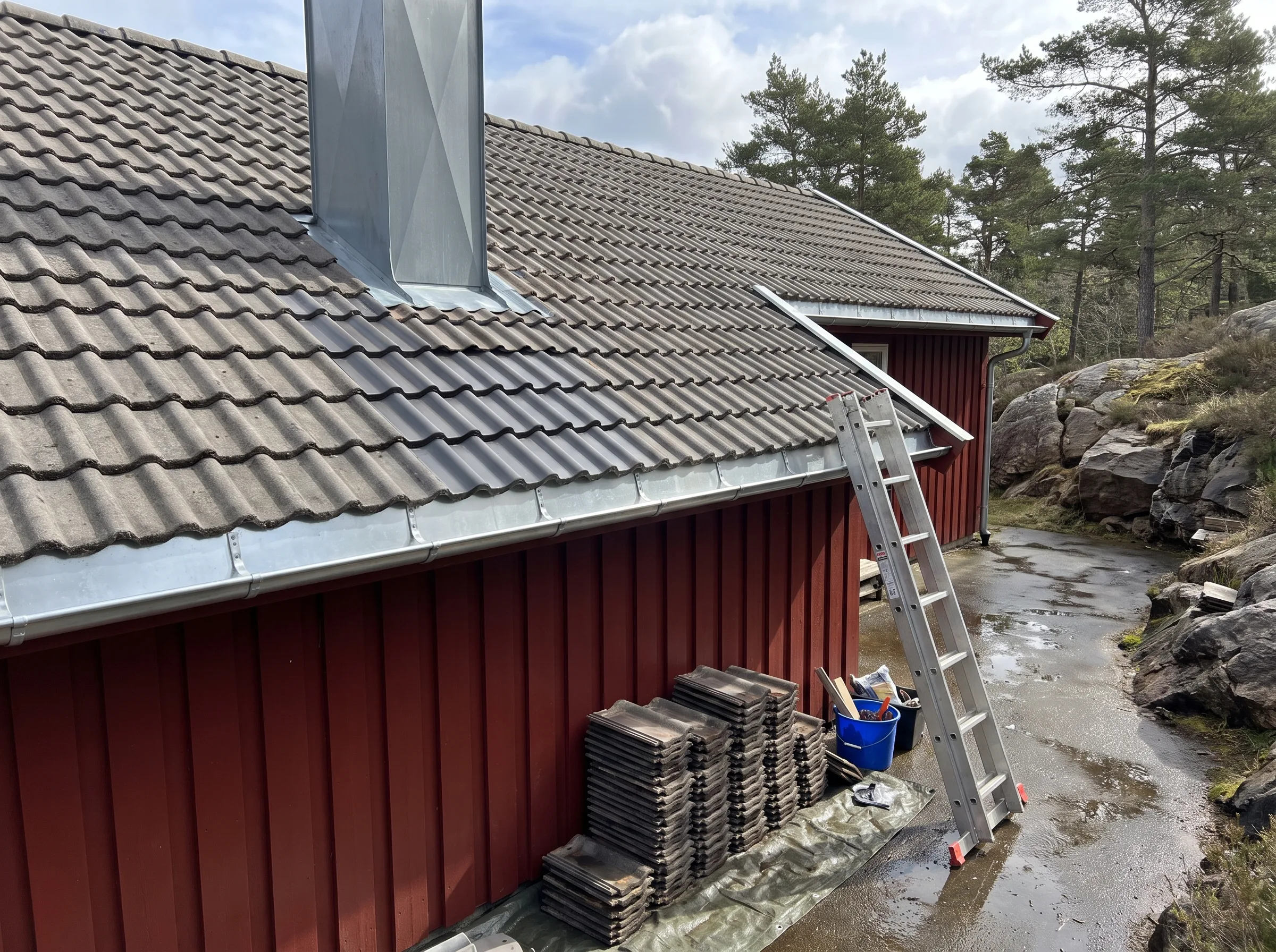 Takomlegging med takstein, stiger ved en rød hytte